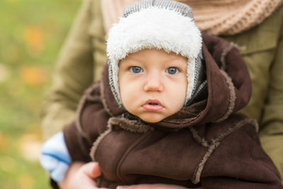 Midsection of mother holding cute baby boy