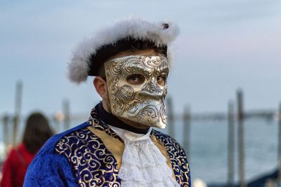 Close-up of person wearing venetian mask 