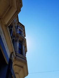 Low angle view of historic building against blue sky