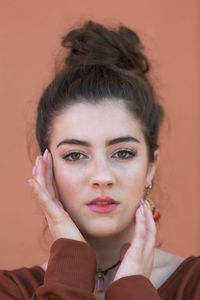 Close-up portrait of teenage girl against colored background