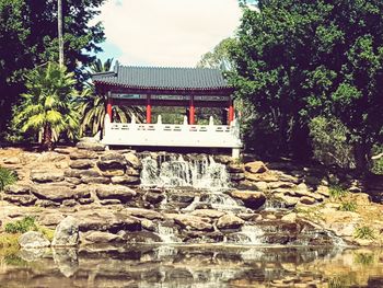 Low angle view of built structure against trees