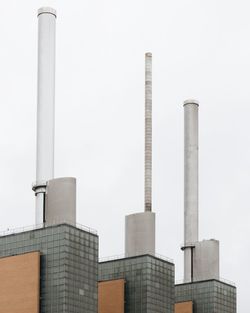 Low angle view of smoke stack against sky