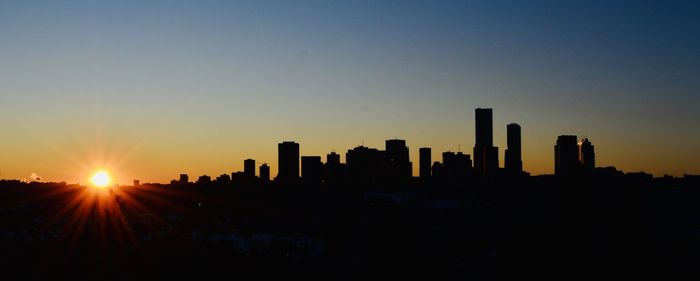 Silhouette buildings against sky during sunset edmonton alberta canada