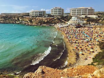 High angle view of sea and buildings against sky