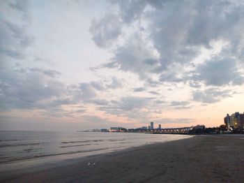 View of beach against cloudy sky