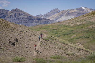 Man hiking on mountain against sky