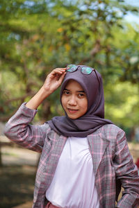 Portrait of young woman standing outdoors