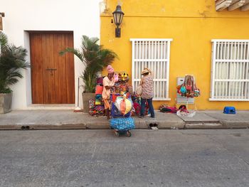 People on street against building