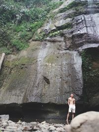 Woman standing on rock in forest