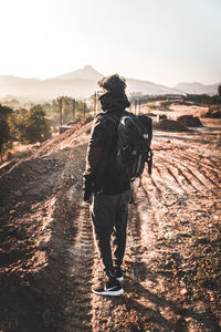 Man walking on field against clear sky