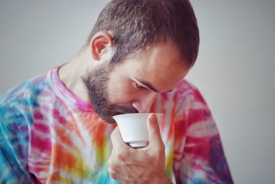 Man drinking coffee indoors