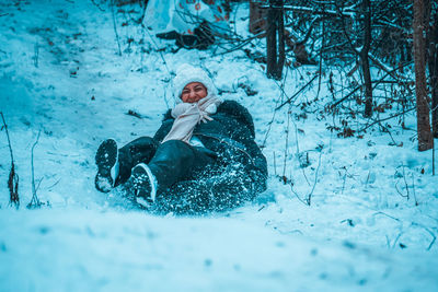 People playing on snow covered land
