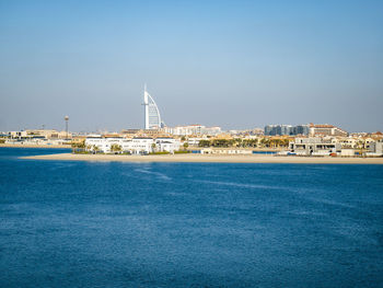 View of city by sea against sky