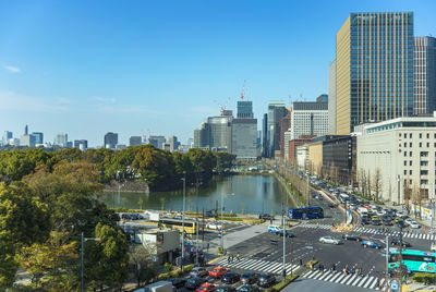 Car traffic at crossing intersection of  hibiya park and  tokyo imperial palace