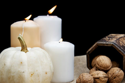 Close-up of candles against black background