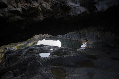 High angle view of man standing on rock