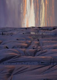Scenic view of land against sky during sunset