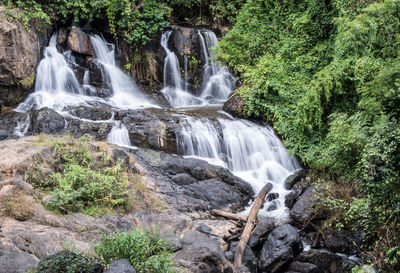 Fresh waterfall from the granite cliff in rainforest of the thai national park.