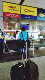 Woman standing at railroad station