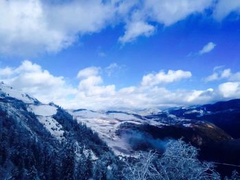 Scenic view of mountains against cloudy sky