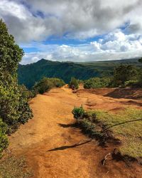 Scenic view of mountains against cloudy sky