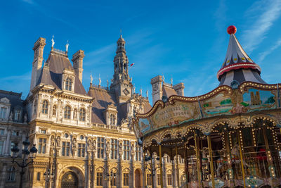 Low angle view of historical building against blue sky