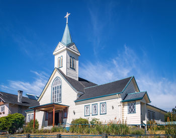 Low angle view of church against blue sky