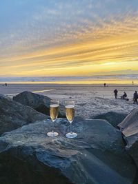 Romantic evening with two glasses of champaign at sunset at cannon beach