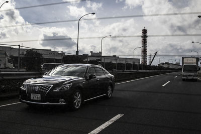 Car on road against sky in city