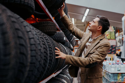 Man choosing tire at store