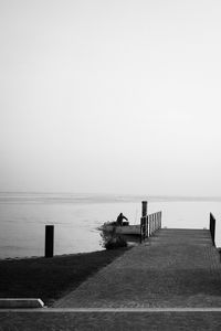 Pier on sea against clear sky