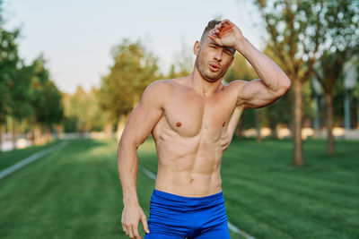 Portrait of shirtless man standing outdoors