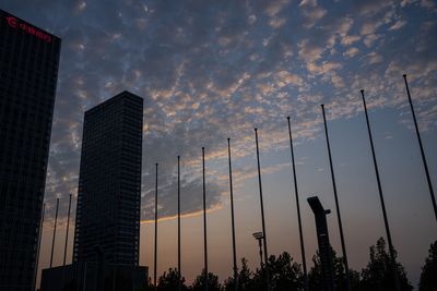 Low angle view of buildings against sky during sunset