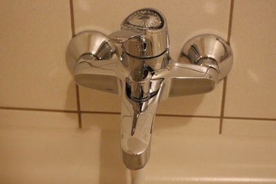 Close-up of faucet in bathroom