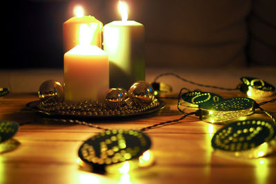 Close-up of lit candles on table