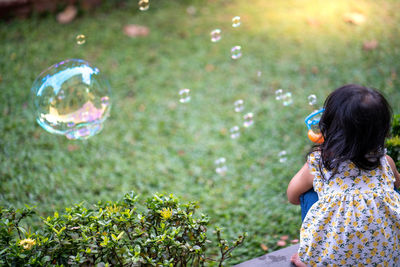 Rear view of woman at bubbles