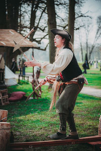 Full length of man standing by tree