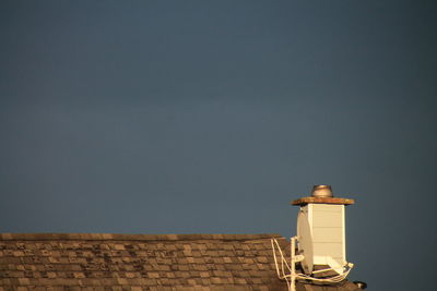 Smoke stack on house against sky