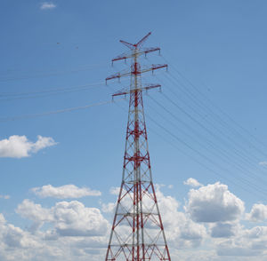 Low angle view of electricity pylon against sky