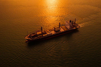 High angle view of ship in sea during sunset