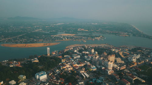 High angle view of townscape by sea against sky