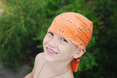 Portrait of smiling boy wearing orange bandana 