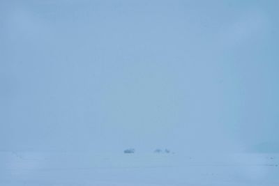 Scenic view of snow against clear blue sky