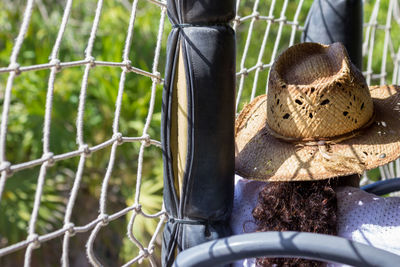 Close-up of person by chainlink fence