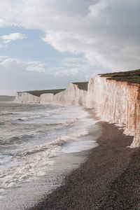 High angle view of pebble beach by seven sisters chalk cliffs in east sussex, uk.