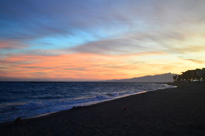 Scenic view of beach against sky during sunset