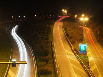 High angle view of light trails on highway at night