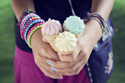 Close-up of hands holding ice cream cones