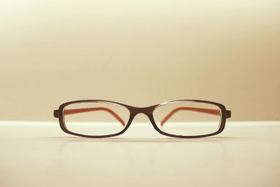 Close-up of eyeglasses on table against white background