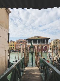 Footbridge leading towards canal in city